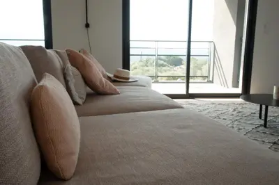 a couch with a hat on it in a living room at So Home in Porto-Vecchio