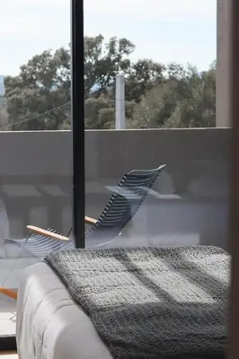 a bird is standing on a window sill at So Home in Porto-Vecchio