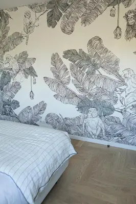 a bedroom with a mural of leaves on the wall at So Home in Porto-Vecchio