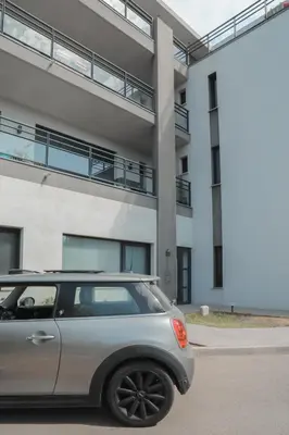a silver car parked in front of a building at So Home in Porto-Vecchio
