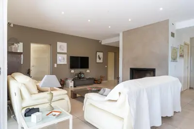 a living room with white furniture and a fireplace at Villa avec piscine privée in Serra-di-Ferro