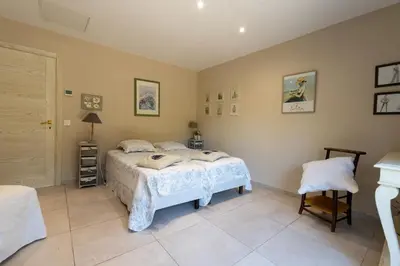 a bedroom with a bed and a chair in it at Villa avec piscine privée in Serra-di-Ferro