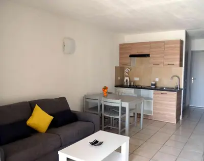 a bathroom with a sink and a shower curtain at Studio piscine et plage in Cervione
