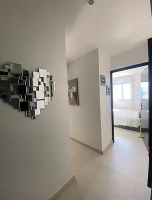 a room with a wall with a heart shaped wall art at Superbe appartement type mini villa vue mer panoramique in Olmeto