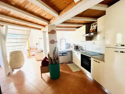a kitchen with a refrigerator and a counter top at Mini-Villa Nacres - Vue mer - clim- Wi-fi -Favone in Conca