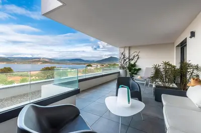 a balcony with chairs and a view of the water at La Vista - Climatisé vue mer in Grosseto-Prugna