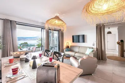 a living room with a couch and a table at La Vista - Climatisé vue mer in Grosseto-Prugna