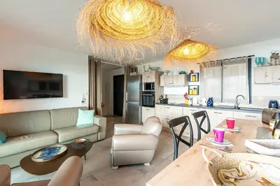 a living room with a couch and a table at La Vista - Climatisé vue mer in Grosseto-Prugna