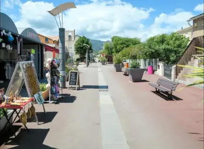 a street in a town with benches and tables at Appartement en bord de mer in San-Nicolao