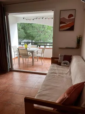 a bedroom with a bed and a dining room with a table at Appartement en bord de mer in San-Nicolao