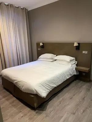 a bedroom with a large bed with white sheets and pillows at Chambre Le Chevalblanc