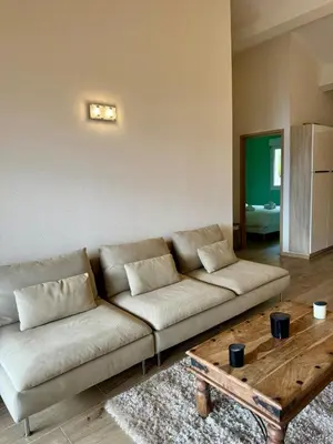a living room with a couch and a coffee table at Mini-villa avec vue mer et piscine in Olmeto