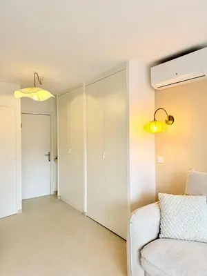 a living room with a couch and a closet at Studio neuf avec terrasse centre de Propriano in Propriano