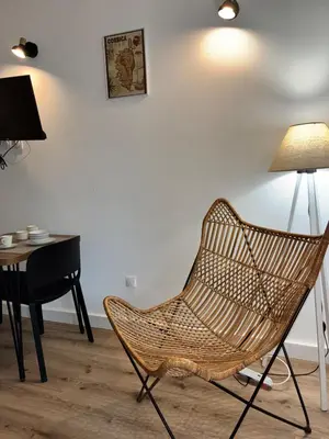 a chair in a room with a desk and a lamp at U Fiori Studio 37 in Lecci