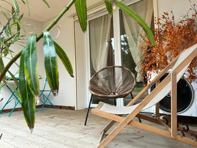 a rocking chair sitting on a porch with plants at U Fiori Studio 37 in Lecci