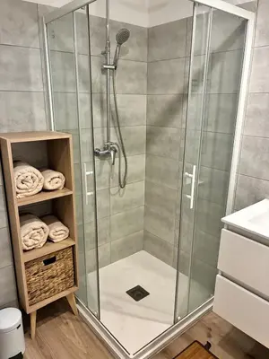 a shower with a glass enclosure in a bathroom at U Fiori Studio 37 in Lecci