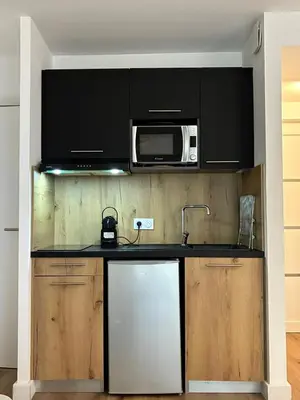 a kitchen with a sink and a microwave at U Fiori Studio 37 in Lecci