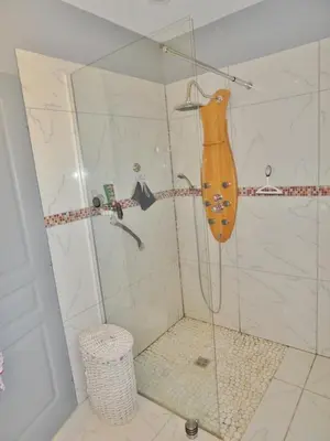 a shower with a glass door in a bathroom at Villa Confina in Villanova