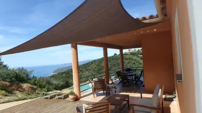 a balcony of a house with a view of the ocean at Villa Confina in Villanova