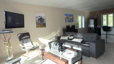 a living room with a couch and a tv at Villa Confina in Villanova