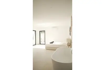 a white bathroom with a toilet and a bed at villa la baies des anges in Calcatoggio