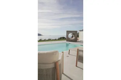 a swimming pool with a view of the ocean at villa la baies des anges in Calcatoggio