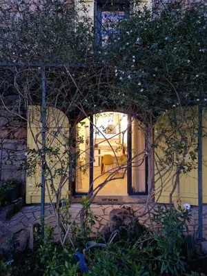 an entrance to a house with an archway at Le vieux moulin in Porto-Vecchio