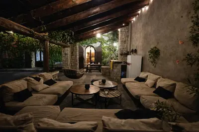 a large living room with couches and a table at Chambres de charmes - 3 chambres indépendantes avec salles de bains privatives in Corte