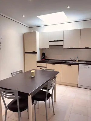 a kitchen with a table and chairs in a room at Mini-villa Lisa 30 Résidence avec piscine Accès plage à pied in Sari Solenzara