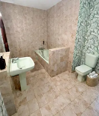 a bathroom with a sink and a tub and a toilet at Chambres de charme in Corte