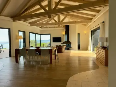 a dining room with a table and chairs at Villa On One Hectare Facing The Gulf Of Ajaccio in Coti-Chiavari