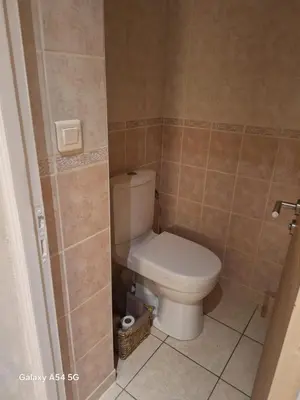 a bathroom with a toilet in a tiled room at Appartement confortable à Propriano avec balcon in Propriano