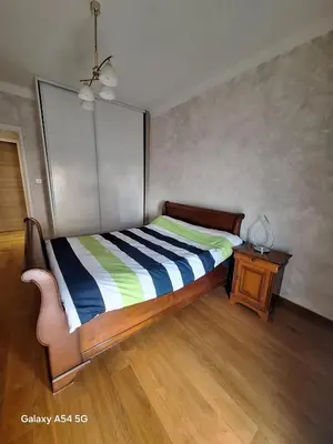 a bedroom with a bed and a table with a lamp at Appartement confortable à Propriano avec balcon in Propriano