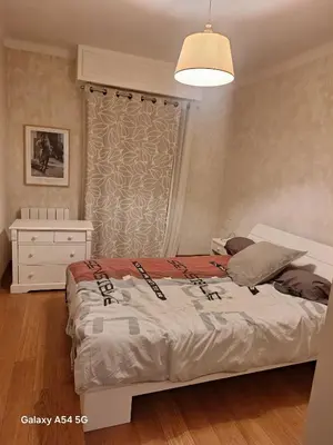 a bedroom with a bed and a dresser and a window at Appartement confortable à Propriano avec balcon in Propriano