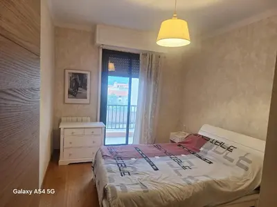 a bedroom with a bed and a window at Appartement confortable à Propriano avec balcon in Propriano