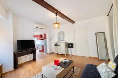 a living room with a couch and a piano at Studio centre-ville rue fesch Ajaccio in Ajaccio
