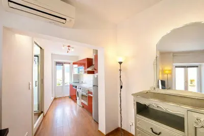 a kitchen with white walls and a table in a room at Studio centre-ville rue fesch Ajaccio in Ajaccio