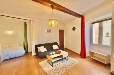 a living room with a couch and a bed at Studio centre-ville rue fesch Ajaccio in Ajaccio