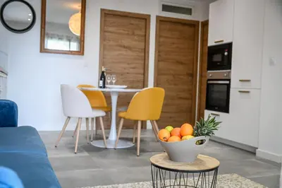 a living room with a table and a bowl of fruit at Résidence Porticcio Vacations Vue Mer Piscine & Jacuzzi in Grosseto-Prugna