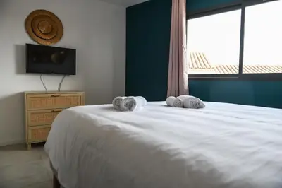 a bedroom with a bed with two towels on it at Résidence Porticcio Vacations Vue Mer Piscine & Jacuzzi in Grosseto-Prugna