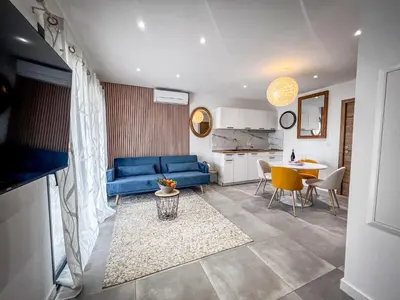a white house with a lot of windows at Résidence Porticcio Vacations Vue Mer Piscine & Jacuzzi in Grosseto-Prugna