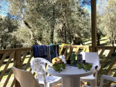 a white table and chairs on a deck at Mobil-home confortable avec terrasse pour 4 personnes à Vico - API-1-52-838 in Vico