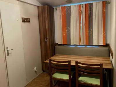 a dining room table with two chairs and a window at Mobil Home avec Terrasse, 2 Chambres, 4 Pers. - API-1-52-840 in Vico