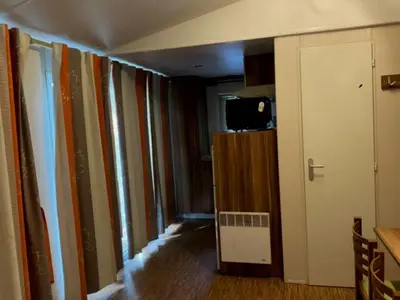 a hallway of a room with a wall of books at Mobil Home avec Terrasse, 2 Chambres, 4 Pers. - API-1-52-840 in Vico