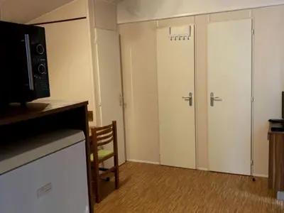 a room with two closet doors and a microwave at Mobil Home avec Terrasse, 2 Chambres, 4 Pers. - API-1-52-840 in Vico