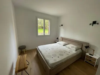 a bedroom with a bed and a window at Superbe appartement Solenzara in Sari Solenzara