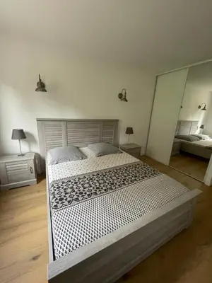 a bedroom with a large bed and a mirror at Superbe appartement Solenzara in Sari Solenzara