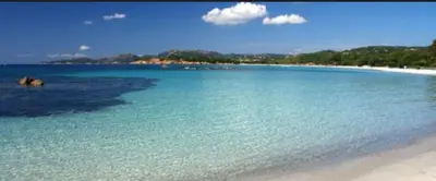 a beach with a large body of blue water at Superbe appartement Solenzara in Sari Solenzara