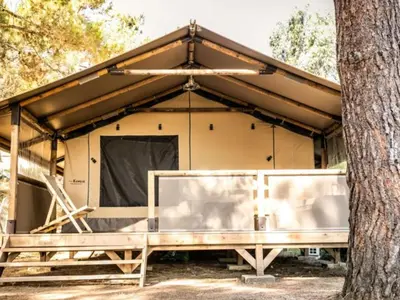a cabin with a tree in front of it at Tente Lodge avec Terrasse - 5 Pers, 2 Ch, Réfrigérateur - API-1-52-1658 in Sartène