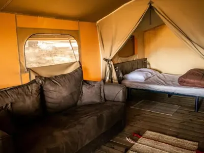 a room with two beds and a couch in a tent at Tente Lodge avec Terrasse - 5 Pers, 2 Ch, Réfrigérateur - API-1-52-1658 in Sartène